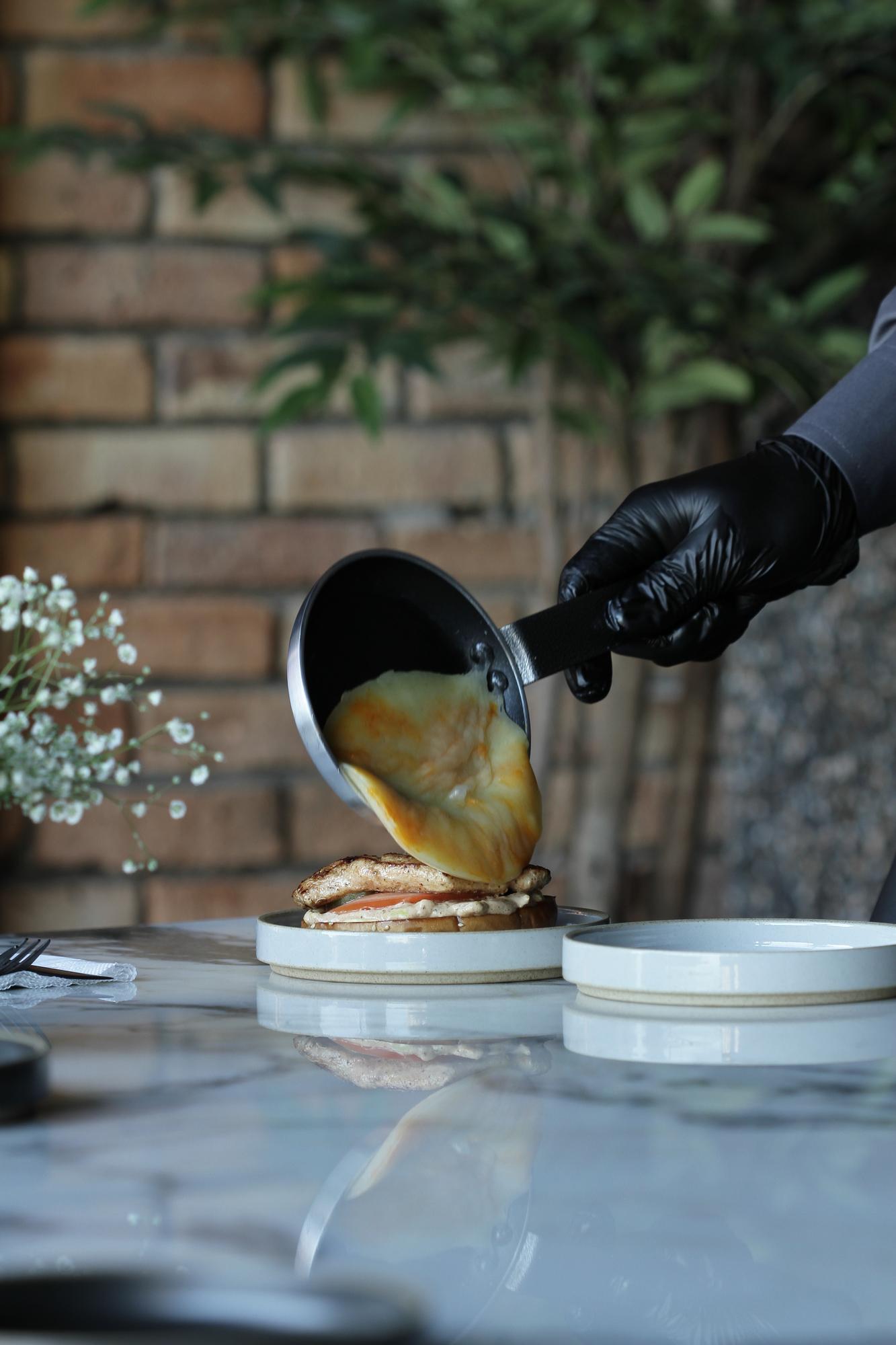chef hands finishing a sauce with precision